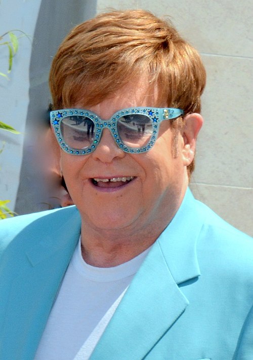 Elton John with striking glasses at a appearance at the Festival de Cannes 2019.